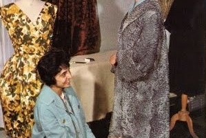 Afghan women engaged in fitting a coat at a dressmaking school in Kabul, 1950s