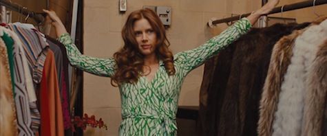 Amy Adams wears a green and white DVF wrap dress in American Hustle