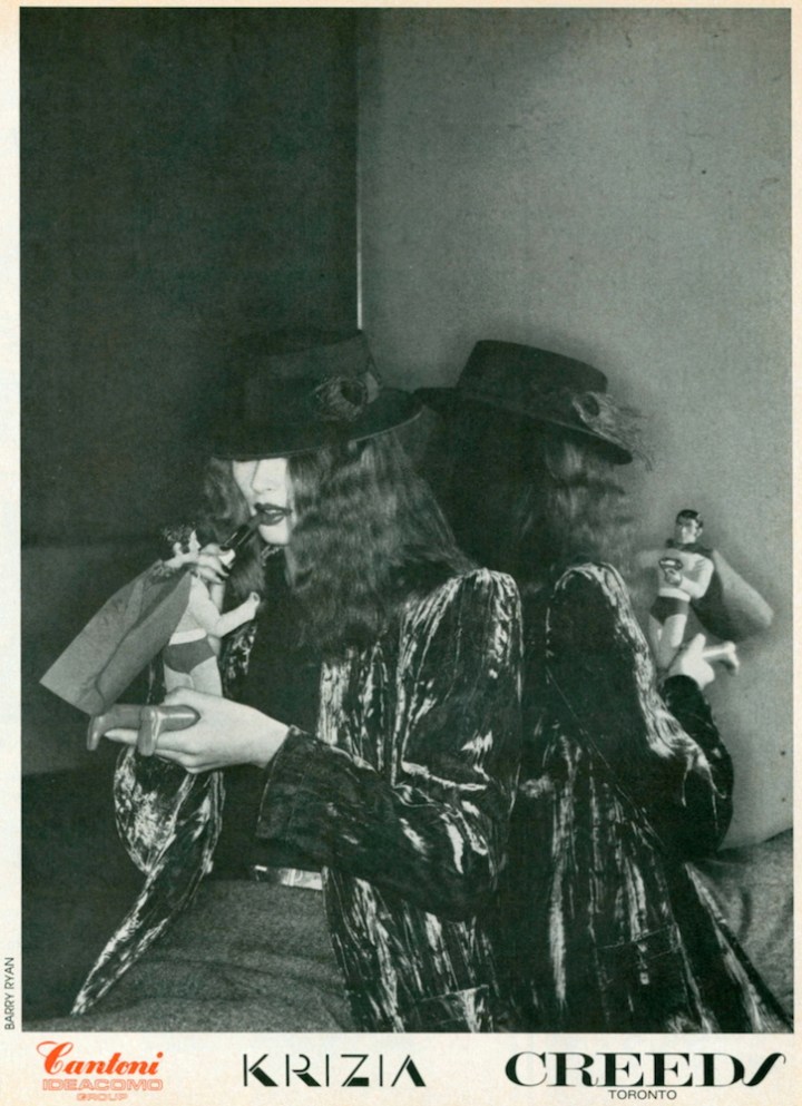 Model touching up lipstick with Superman figure - Cantoni - Krizia - Creeds Fall 1979 advertising campaign photographed by Barry Ryan