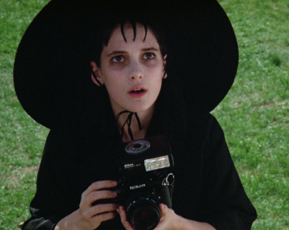 Lydia Deetz (Winona Ryder) with her Nikon camera in Tim Burton's Beetlejuice (1988)