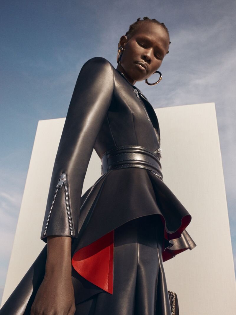 Shanelle Nyasiase photographed by Chloé Le Drezen in a black leather jacket and skirt - Alexander McQueen Resort 2020