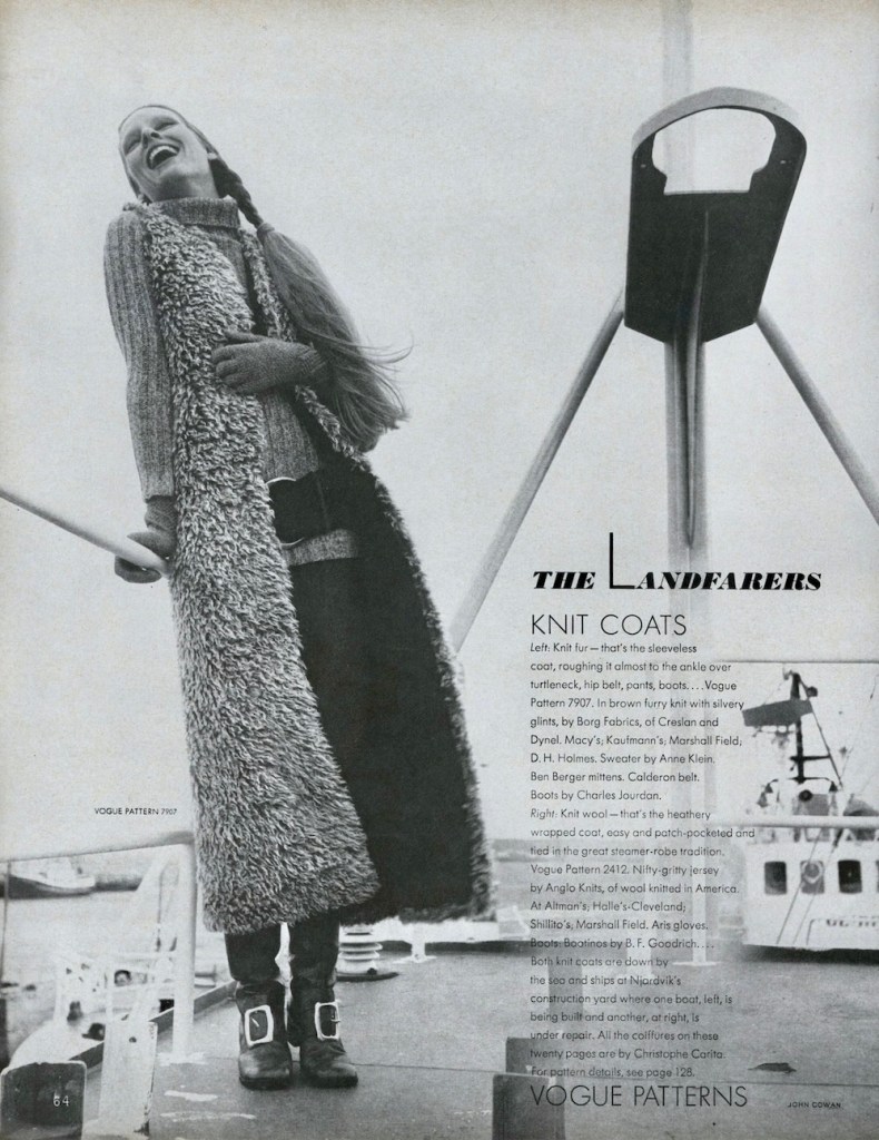 A laughing model stands on a ship's deck in a turtleneck sweater, long, faux-sheepskin vest, and buckle boots