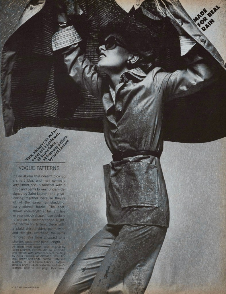 Black and white photo of a model in sunglasses looking upward and caught in the rain, wearing a water-repellent, belted tunic and pants made using Vogue pattern 2814 and holding a trapeze-style raincoat over her head